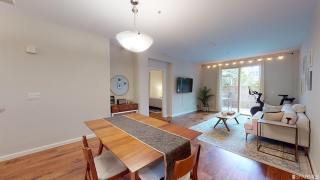 dining space with hardwood / wood-style floors