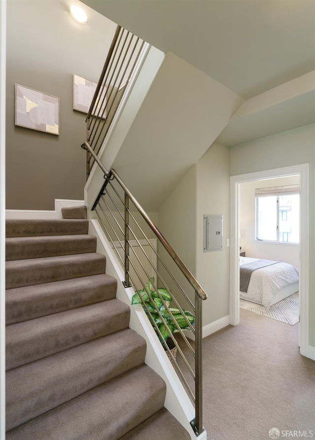 3310 19th St Unit 303, San Francisco, CA 94110 - staircase with baseboards, carpet floors, electric panel, and vaulted ceiling