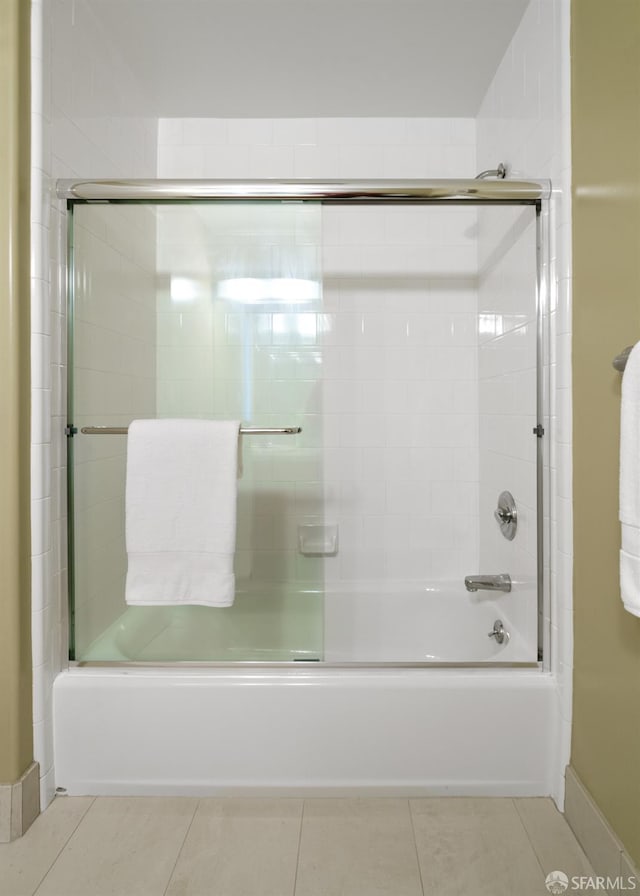 3310 19th St Unit 303, San Francisco, CA 94110 - full bath featuring shower / bath combination with glass door, tile patterned flooring, and baseboards