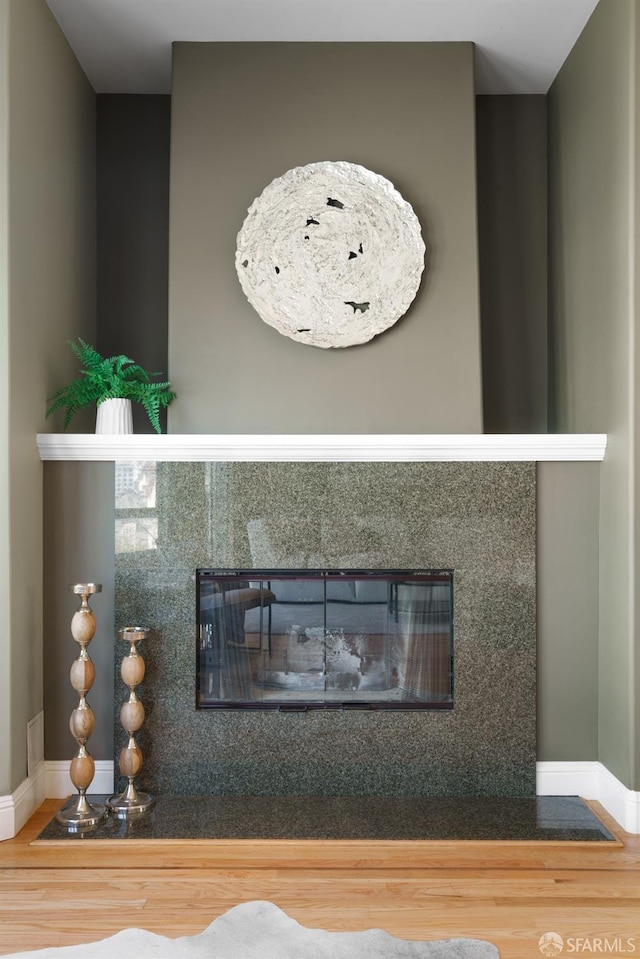3310 19th St Unit 303, San Francisco, CA 94110 - detailed view of a fireplace with flush hearth, wood finished floors, and baseboards