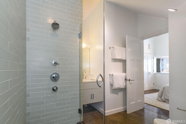 bathroom featuring vanity, a shower with shower door, and hardwood / wood-style floors