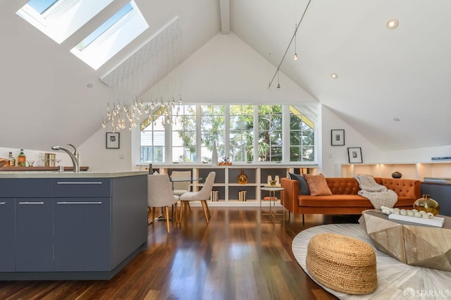 living room featuring sink, a skylight, high vaulted ceiling, dark hardwood / wood-style floors, and beam ceiling