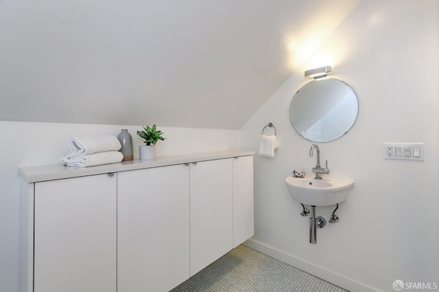 bathroom with vaulted ceiling and sink