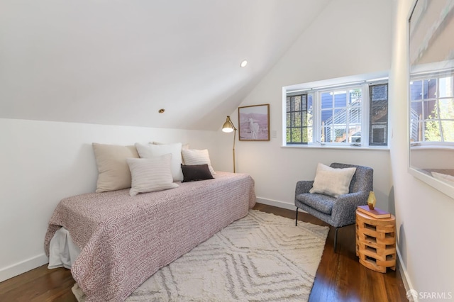 bedroom featuring dark wood-type flooring and vaulted ceiling