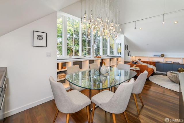 dining area featuring vaulted ceiling, dark hardwood / wood-style floors, and a notable chandelier