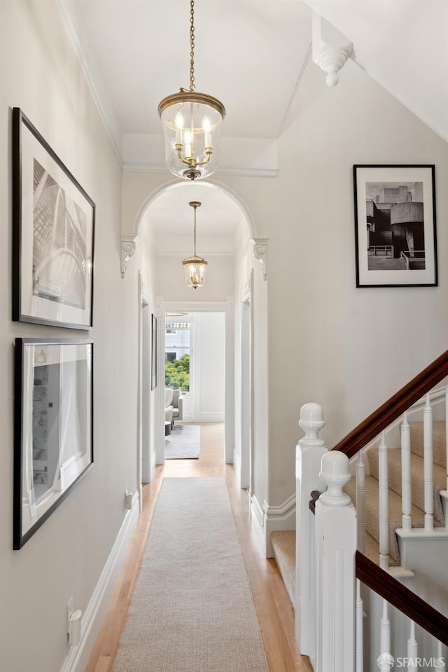 2531 Gough St, San Francisco, CA 94123 - hall featuring arched walkways, light wood-style flooring, a chandelier, ornamental molding, and stairway