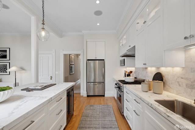2531 Gough St, San Francisco, CA 94123 - kitchen featuring appliances with stainless steel finishes, beverage cooler, white cabinetry, tasteful backsplash, and light wood-style floors