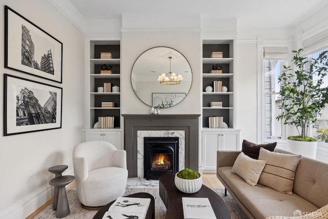 2531 Gough St, San Francisco, CA 94123 - living room featuring wood finished floors, built in features, a chandelier, and a fireplace
