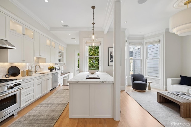 2531 Gough St, San Francisco, CA 94123 - kitchen featuring appliances with stainless steel finishes, light wood finished floors, white cabinetry, glass insert cabinets, and backsplash