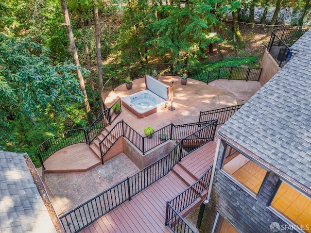 wooden deck with an outdoor hot tub