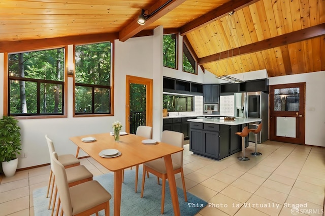 tiled dining space featuring wood ceiling, lofted ceiling with beams, and sink