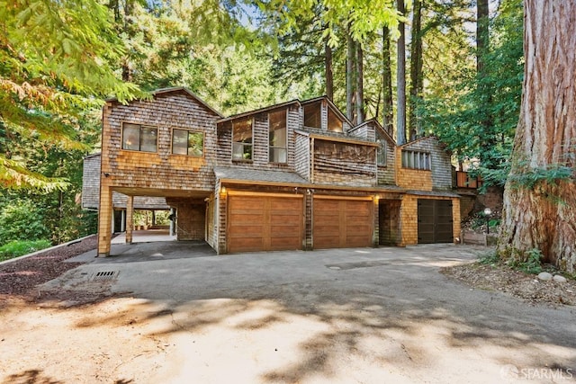 view of front facade with a garage and a carport