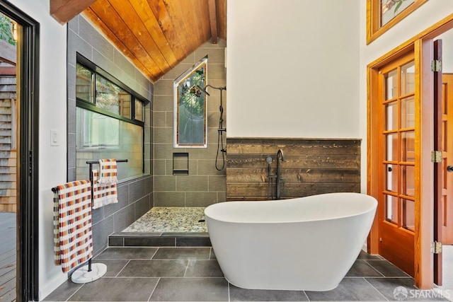 bathroom with tile walls, wood ceiling, lofted ceiling with beams, shower with separate bathtub, and tile patterned floors