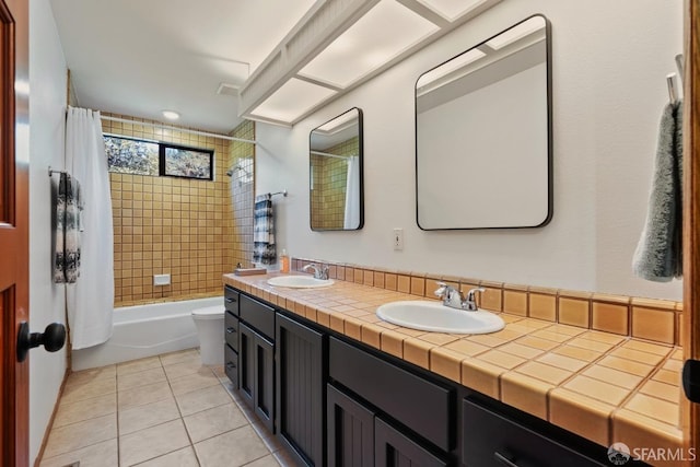 full bathroom with vanity, shower / bath combo with shower curtain, toilet, and tile patterned floors