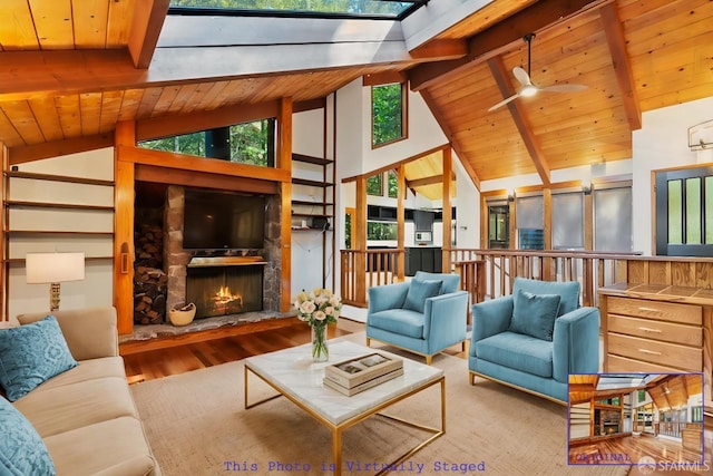 living room with wood ceiling, wood-type flooring, beamed ceiling, a fireplace, and ceiling fan