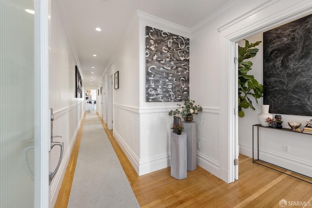 hallway featuring ornamental molding and hardwood / wood-style floors