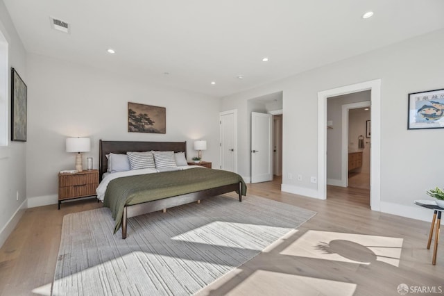 bedroom with light wood-style floors, recessed lighting, visible vents, and baseboards