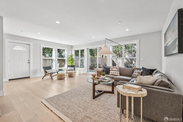 living room featuring recessed lighting, light wood-type flooring, and baseboards