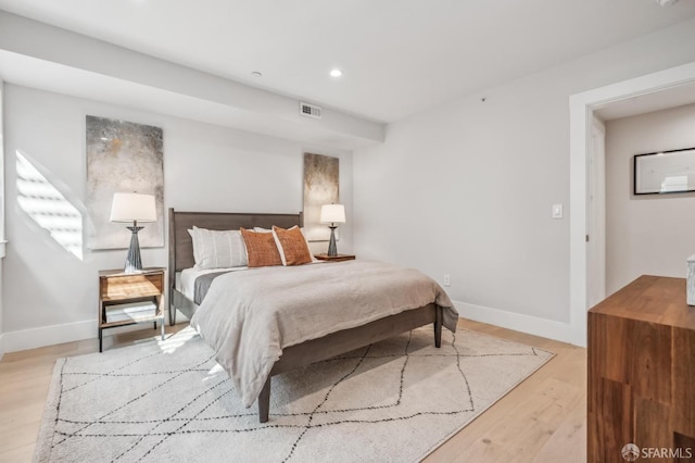 bedroom with recessed lighting, baseboards, and light wood finished floors