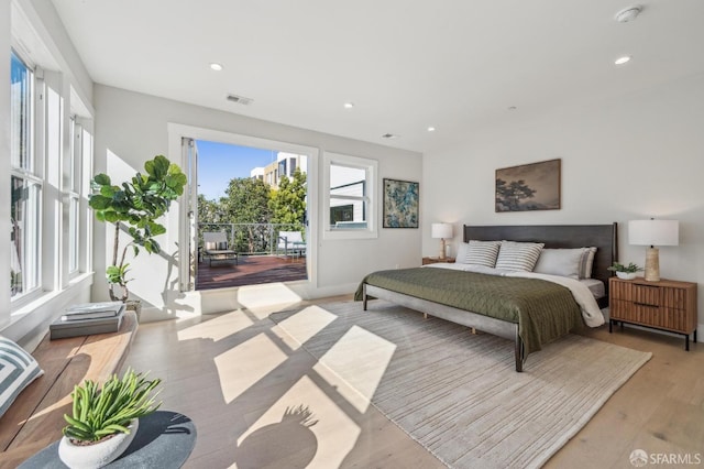 bedroom with recessed lighting, visible vents, light wood-style flooring, and access to outside