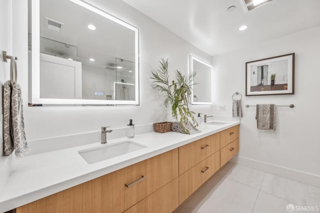 full bathroom featuring double vanity, visible vents, and a sink