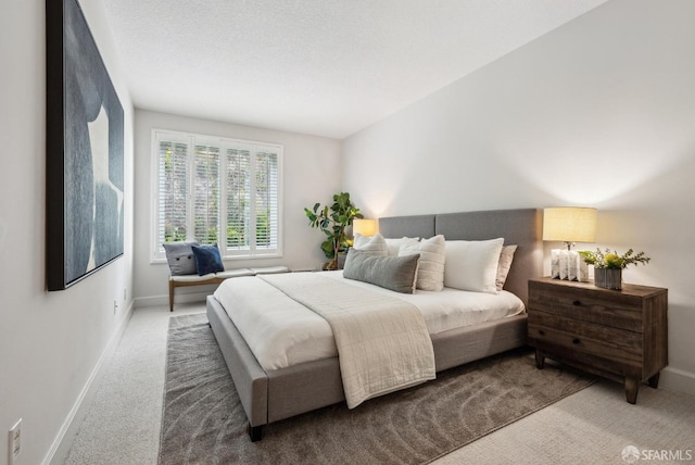 bedroom featuring carpet floors and baseboards