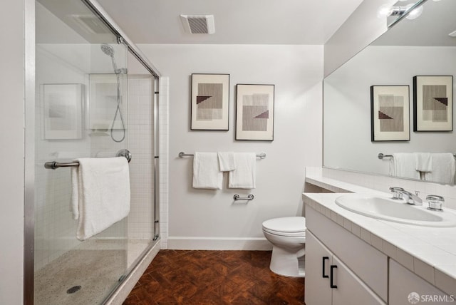 bathroom with vanity, toilet, baseboards, a shower stall, and visible vents