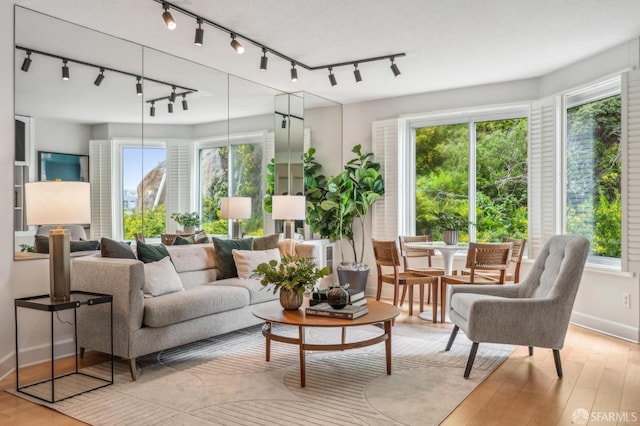 sunroom featuring rail lighting