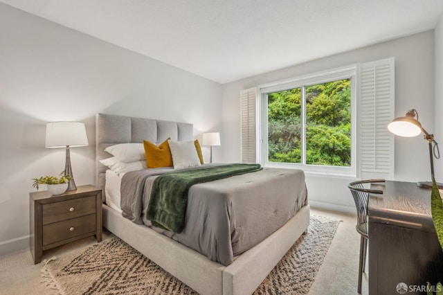carpeted bedroom featuring baseboards