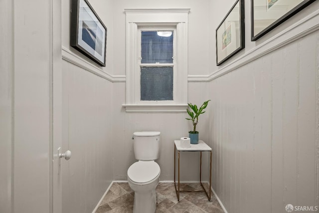 bathroom featuring wainscoting and toilet