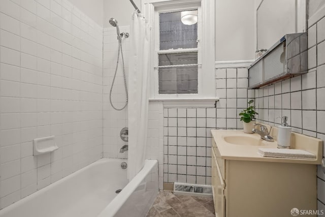 full bathroom featuring shower / tub combo, tile walls, and vanity