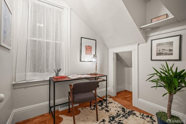 home office featuring lofted ceiling, baseboards, and wood finished floors