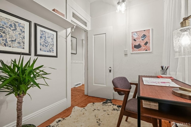 office area featuring wood finished floors and visible vents