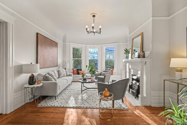 living room featuring a fireplace with flush hearth, a chandelier, and light wood-style flooring