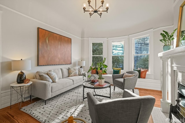 living area featuring a premium fireplace and an inviting chandelier