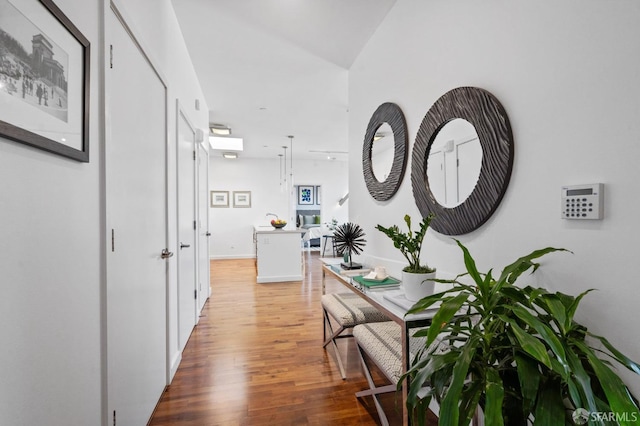 corridor with hardwood / wood-style flooring