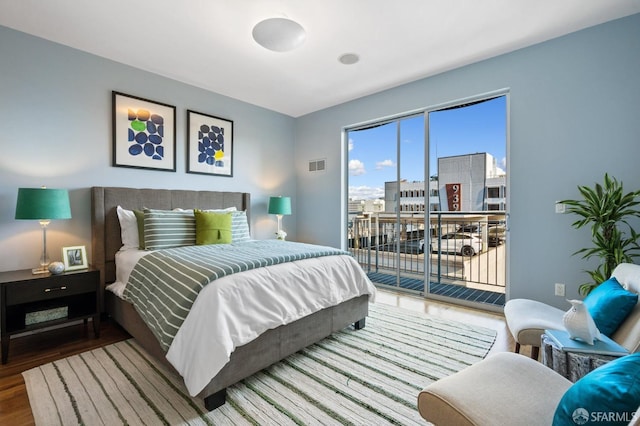 bedroom featuring hardwood / wood-style flooring and access to outside