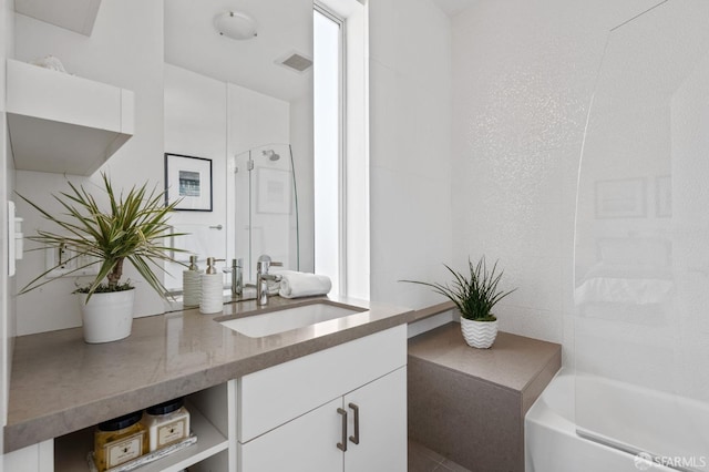 bathroom with vanity and shower with separate bathtub