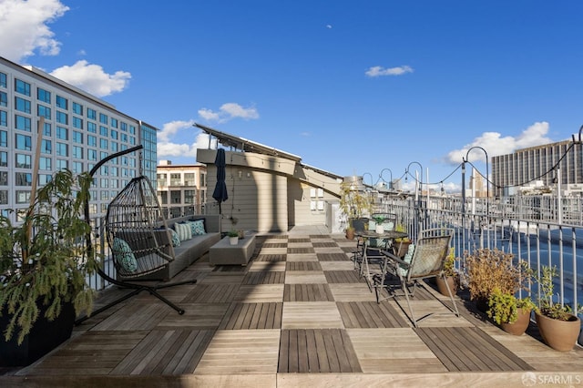 deck featuring an outdoor living space and a water view