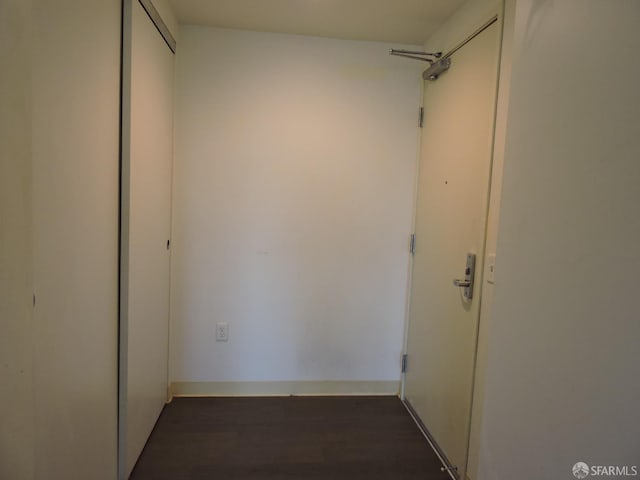 hallway with dark hardwood / wood-style floors