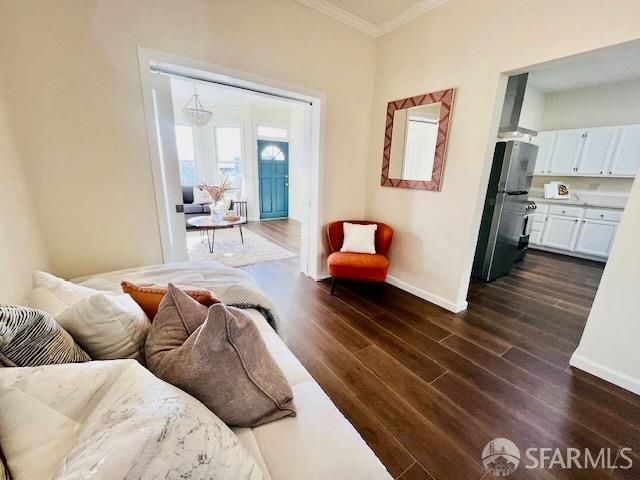 living room with ornamental molding and dark hardwood / wood-style floors