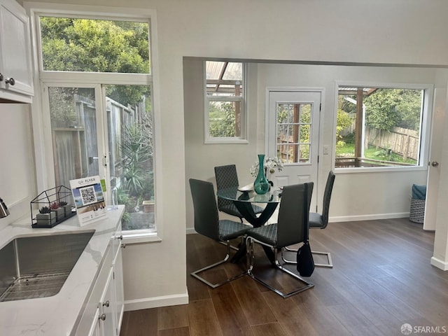 dining area with dark hardwood / wood-style flooring and sink