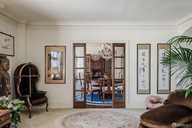 living area featuring a chandelier, ornamental molding, carpet flooring, and baseboards