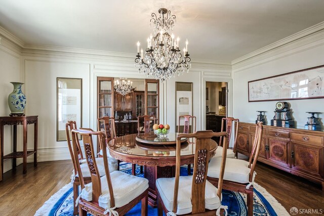 dining area with a chandelier, dark wood-type flooring, and ornamental molding