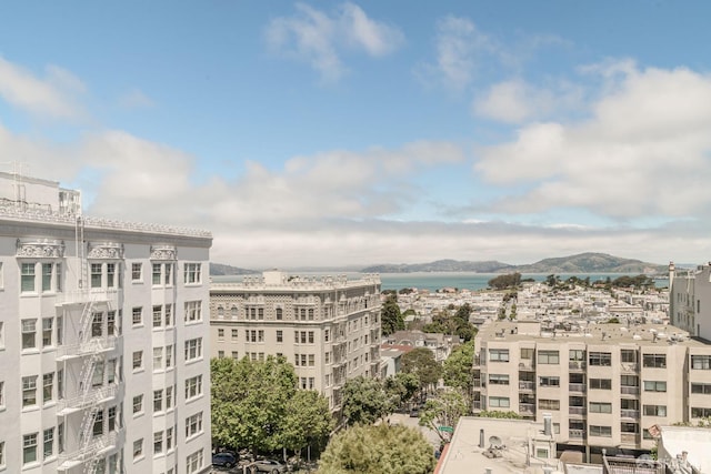 exterior space featuring a city view and a water and mountain view