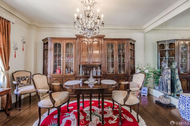 dining room with ornamental molding, a notable chandelier, and wood finished floors