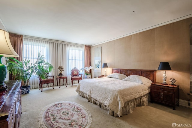 bedroom featuring light carpet