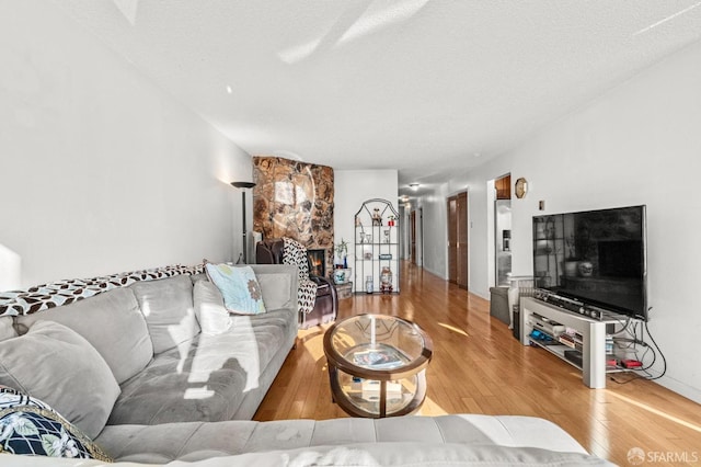living area featuring a textured ceiling and wood finished floors