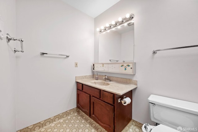 half bathroom with toilet and vanity
