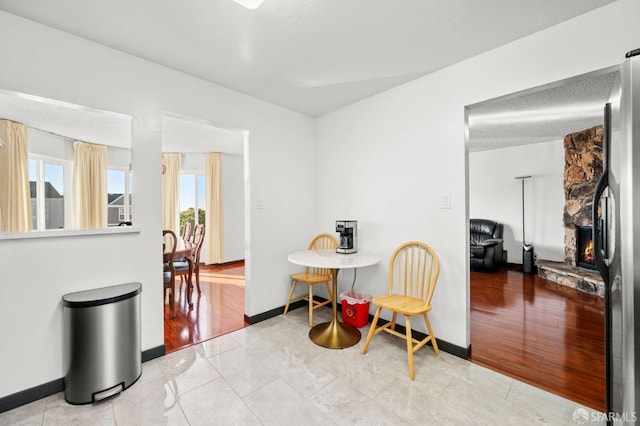 sitting room featuring a fireplace and baseboards